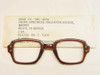 USS 6540-01-146-4274 military spectacle front, brown cellulose acetate horn-rim frame, shown with original DLA contract sleeve label
