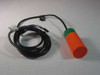 Efector KB-3020-BPKG inductive proximity sensor switch — full view showing orange cylindrical housing with green collar and attached black cable coiled