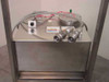 Top view of stainless steel chemical tank showing circular lid, quick-connect couplings, NFPA Xylene hazard labels, and wiring