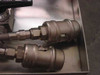 Close-up of two stainless steel quick-connect couplings on the front of the chemical cart tank