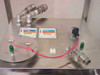 Top of stainless tank showing two NFPA Xylene hazard labels, dual outlet ports, quick-connect fitting, and electrical connector