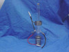 TMA quartz sample holder full assembly against blue fabric background — showing complete glass tube, stainless steel base, and all lead wires