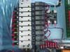 Close-up of SMC VZ2150 solenoid valve bank with nine valves mounted on manifold, G120D10 solid state relays visible, red and black wiring connections