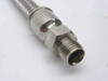 Close-up of stainless steel compression fitting on end of braided hose showing hex nut and male threaded end