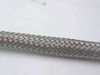 Close-up of stainless steel wire braid construction along the body of the flexible hose