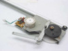 Rear three-quarter view of linear carriage mechanism showing stepper motor, gear/pulley drive wheel, and driver PCB with wire harness