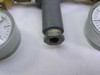 Close-up of 1/4 NPT inlet fitting at top of manifold body showing threaded female connection and painted steel housing