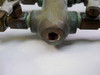Close-up of 1/8 NPT inlet port on brass manifold body showing threaded opening