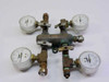 4-outlet low pressure brass gas manifold with four 0–15 PSI gauges mounted, front view showing T-handle shutoff valves