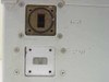 Avantek ASAT-1214-1004 rear panel WR75 waveguide ports — upper INPUT port (shows oxidation/corrosion on flange face) and lower OUTPUT port with blank cover