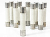 Fusetron MDA-10 dual-element fuses – group of 10 standing upright, stamped markings visible on end caps