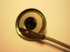 SMC D-A93 magnetic sensor positioned against circular magnet surface showing red LED indicator illuminated