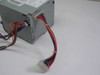 Apple 590-0873B power cable connected to an Apple power supply unit — showing the 22-pin connector plugged into a gray metal PSU