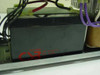 APC Back-UPS 600 interior view showing installed CSB battery with red and black wiring and purple cables