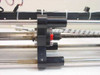 Mycom BRA85-10 center carriage close-up showing lead-screw nut, red bearing, and dual linear guide rails with wear