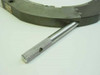 Close-up of knurled stainless steel thumb screw adjustment rod removed from the ring stage
