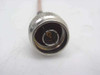 Close-up of N-Male connector end on ESM Cable Corp RG-142 coaxial cable showing center pin and knurled coupling nut