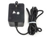 Microcom 13-0000004-001 AC adapter back view showing QC Tested and QC Passed stickers with output cable and proprietary connector
