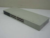 Unicom Dyna-Switch/24 FEP-31024T-1 24-port 10/100 Ethernet switch — front-left angled view showing 24 RJ-45 ports