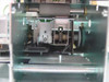 Interior close-up of Evolis Kiosk printhead carriage area — printhead mount visible with empty carriage (no printhead installed), spring mechanism, and drive gears