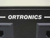Ortronics brand name detail on patch panel front face – white lettering on black panel