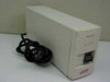 APC Back-UPS 250 UPS front-left angled view showing cream housing, on/off rocker switch, and coiled AC power cord