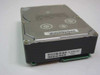 Quantum Atlas III 18.2GB 3.5-inch SCSI hard drive — angled top-right view showing drive top cover with warranty seals and barcode label with serial number