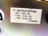 RU 8631 power supply output rating label close-up — reads: +5V 15A DC, +12V 4.2A DC, -12V 0.4A DC, part number 101-6906-25