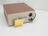 Rudolph Model 600 Power Supply – rear panel view showing output connector and sticky note; handle visible on right side