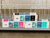 HP DesignJet ink cartridge boxes — black, magenta, and cyan dye cartridges on lower shelf of stand