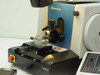 Reichert-Jung 2050 SuperCut specimen stage and knife holder close-up — knife holder with angle adjustment, specimen chuck mounted, control panel partially visible at right