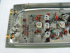 Interior PCB view of a removed Quintron modulator card showing analog circuitry with discrete resistors, capacitors, inductors, and trimmer potentiometers on metal substrate