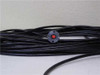 Mitsubishi STU600F Diaguide fiber optic cable coiled showing collimator end with red laser light transmitted through fiber