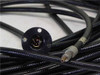 Both ends of Mitsubishi STU600F cable visible — collimator flange end and bare ferrule end alongside coiled cable