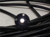 Mitsubishi STU600F collimator end transmitting white light through fiber, bright spot visible at aperture