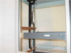 Varian 1015230 rackmount enclosure interior side view showing vertical black column, horizontal waveguide rail, and rear panel cabling