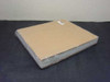 Soda lime glass plates — large wrapped stack of thin 14x14 plates bundled between cardboard sheets, side top view