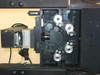 Elicon Ultradrive 600 film transport mechanism — open side access panel revealing toothed sprocket gears, drive pulleys, and film gate assembly; projection/light source module visible at left
