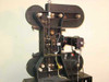 Elicon Ultradrive 600 — side view showing film transport column, film path rollers, tension arms, exposed servo/motor module at right, and interconnecting wiring