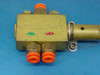 Clippard brass pneumatic valve close-up — Cincinnati OH markings visible, orange push-in fittings on all ports, mounted to blue anodized plate