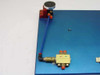 Air Safety dual hand safety switch — close-up of left palm button assembly with blue pneumatic tubing running to Clippard valve below on blue anodized plate