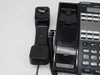 Panasonic VB-44223-B black handset removed from cradle showing speakerphone grille and handset cord