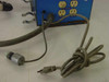 Rear view of Lakewood Instruments Model 200 showing three outlets, pipe clamp bracket hardware, power cord, and solenoid valve assembly with hose