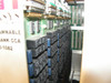 Interior detail of Maxsys 465-1082 Programmable Load Bank CCA — rows of blue relays on green PCB, edge connector card guides visible
