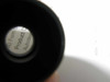 Bottom view of optical tube end showing partially legible internal label (text not fully readable)