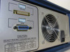 Tau-Tron STX-1101 rear panel close-up showing RS-232 connector, GPIB connector, power requirements label (120VA/75W, 47-440Hz), line voltage selector, fuse holders, and cooling fan