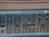 Tau-Tron STX-1101 front panel close-up showing Data Pattern (2^6-1, 2^9-1, 11110000), Error Inject (Internal/External, Error Rate, Single), Sync Outputs (Pattern, Clock TTL, Data 50 Ohm), and Data Output (Amplitude, Baseline Offset, Preset/Variable) controls