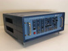 Tau-Tron STX-1101 Bit Error Rate Transmitter – three-quarter front-left view showing blue benchtop enclosure with front panel controls and carry handles