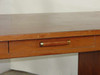 Executive 3460 desk drawer front detail showing cylindrical brass-tone pull handle and surface wear