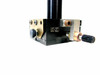 Close-up of linear stage base showing drag screw knob, brass collar, stainless adjustment screw, and mounting hardware detail
